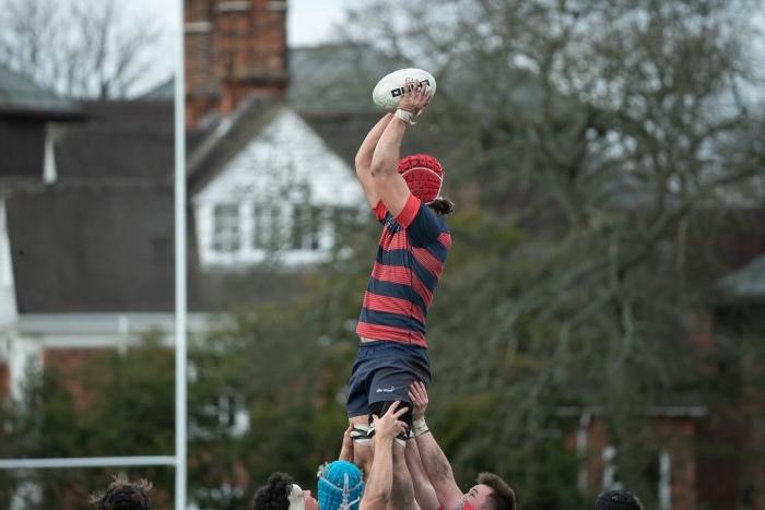 SMC Rugby player holding a ball in a game against Cambridge