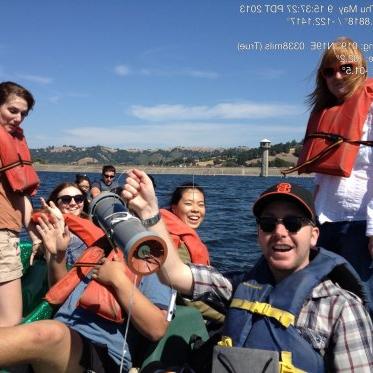 EES students on a fieldtrip, on a boat wearing life vests in a reservoir
