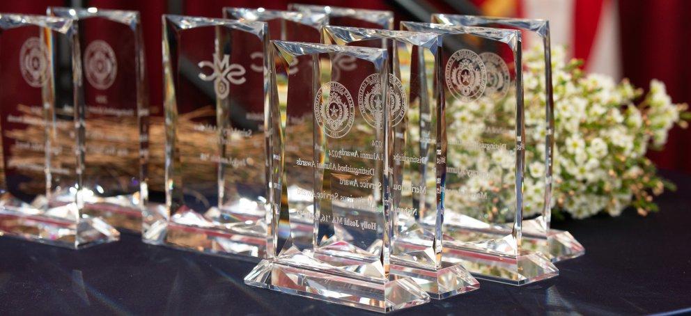 Glass trophies with white flowers at the Alumni Awards Ceremony