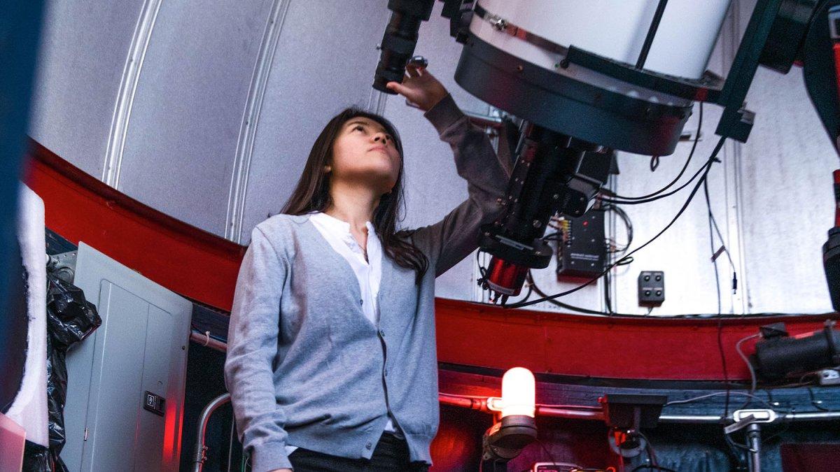 Person looking through large telescope